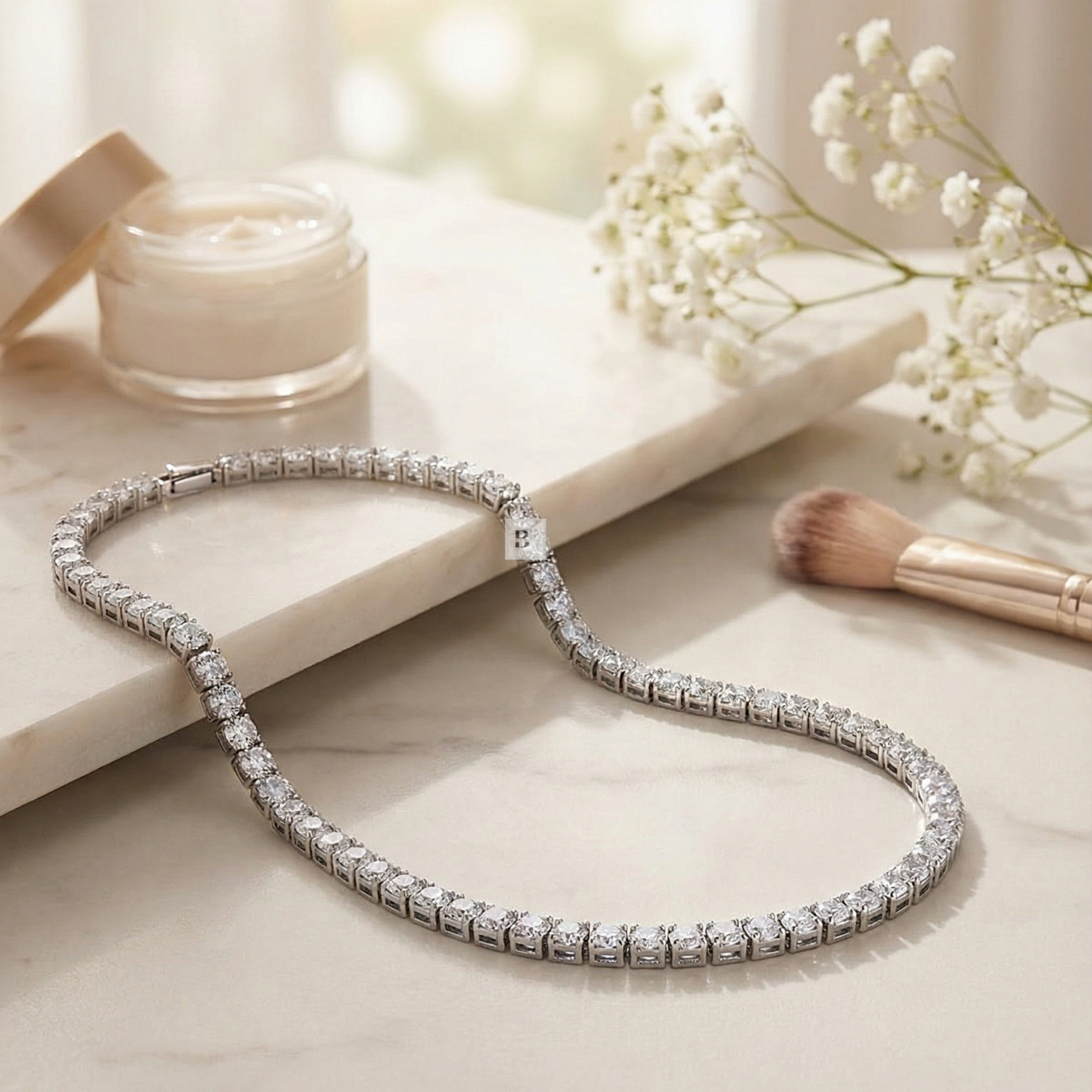 Silver tennis necklace with diamonds on a light surface with a blurred background