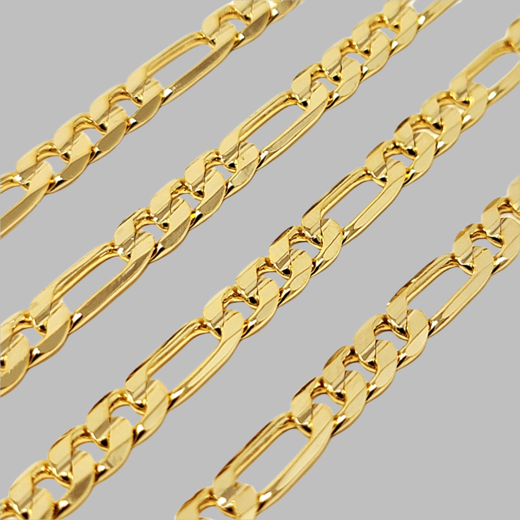 Gold Figaro chain on a white background
