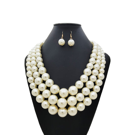 Cream Pearl necklace and earrings set on a black mannequin bust against a white background