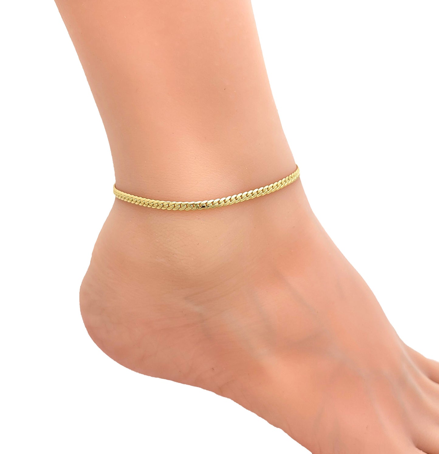 Gold anklet on a person's ankle against a white background