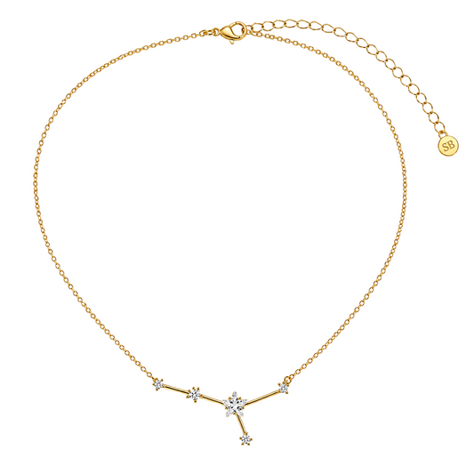 A gold chain necklace featuring a constellation pendant with clear gemstones, displayed on a clean white background.
