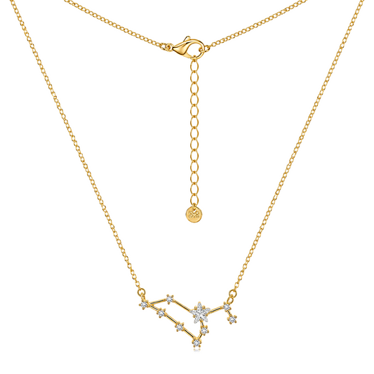 Gold necklace with a constellation pendant featuring clear gemstones, shown on a white background with a close-up of the clasp and extender chain.
