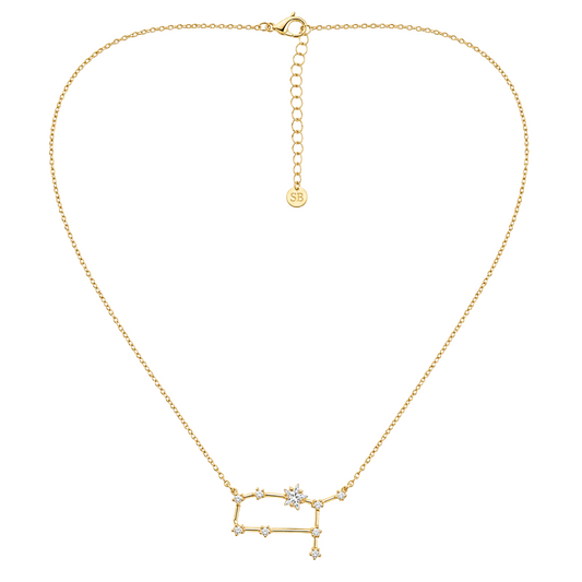 A gold chain necklace with a pendant featuring a constellation design accented with small clear gemstones, displayed on a clean white background.