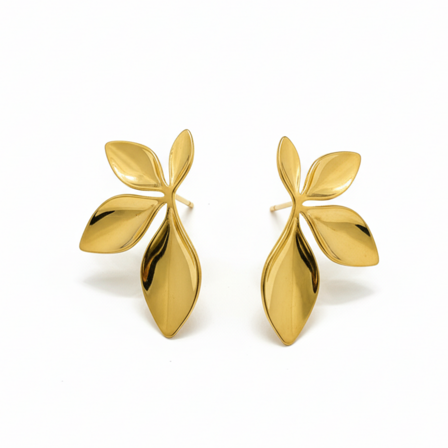 Pair of gold leaf-shaped earrings on a white background