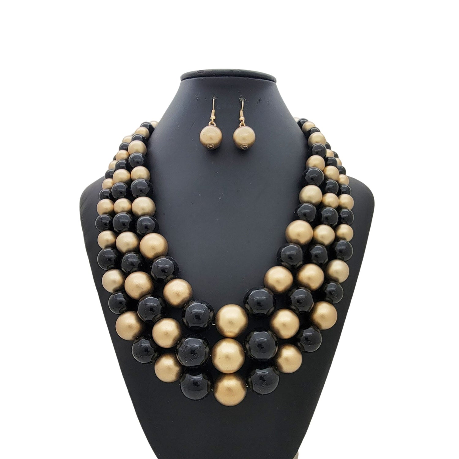 Black and gold beaded necklace and earrings set on a black mannequin bust.
