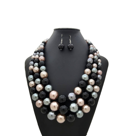 Black Mix Pearl necklace and earrings set on a black mannequin bust with a white background