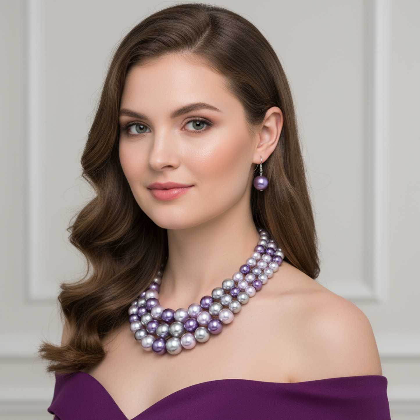 Woman wearing a multi-layered pearl necklace and earrings against a neutral background