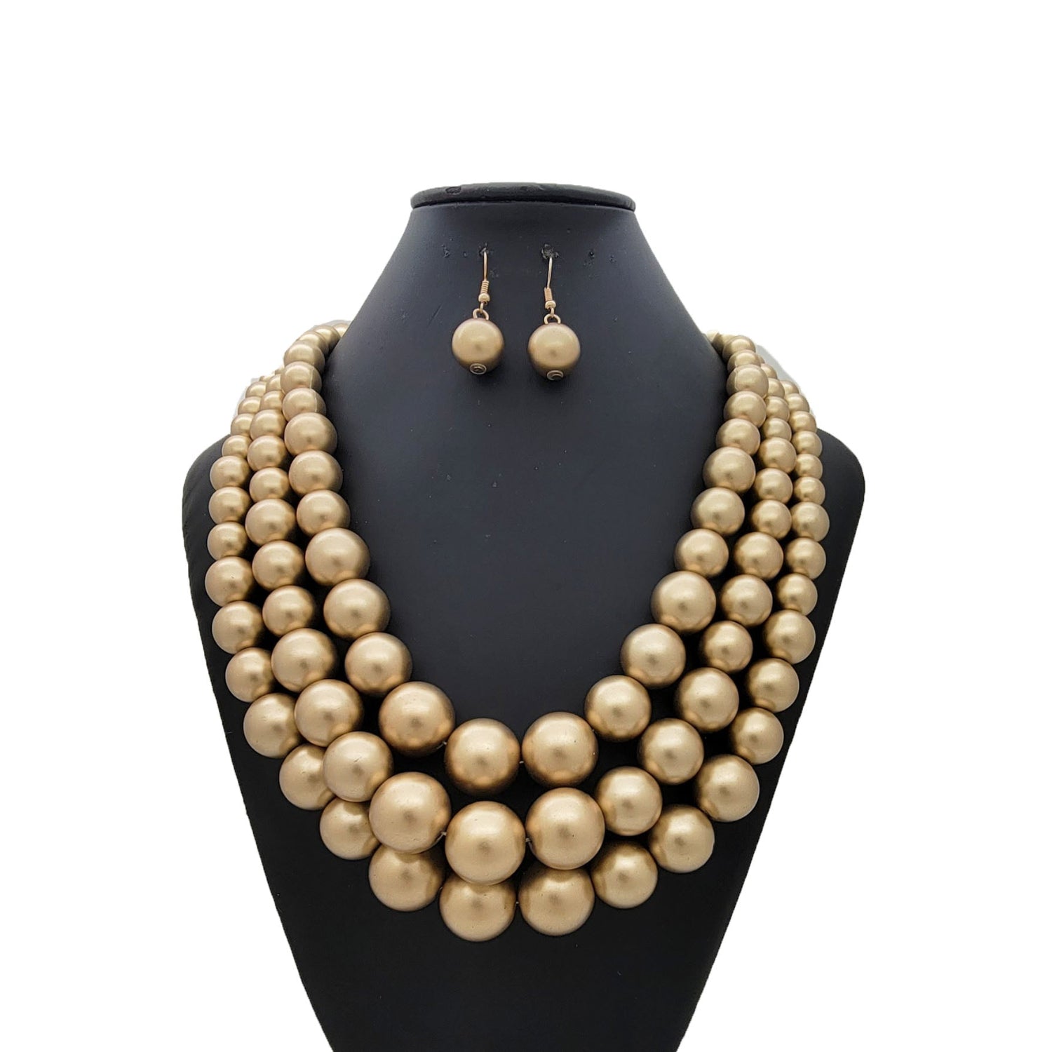 Pearl necklace and earrings set on a black mannequin bust against a white background