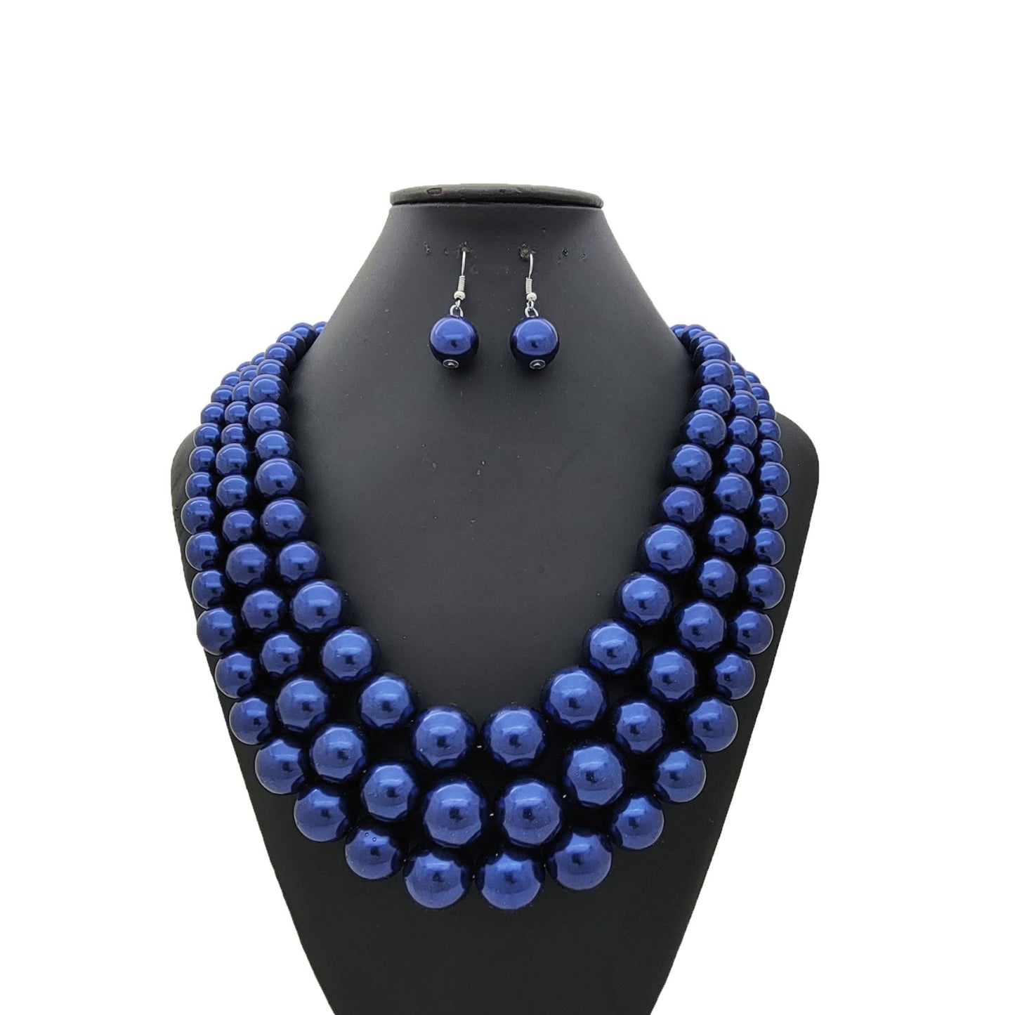 Blue beaded necklace and earrings set on a black mannequin bust against a white background
