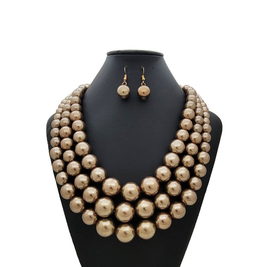 Pearl necklace and earrings set on a black mannequin bust against a white background