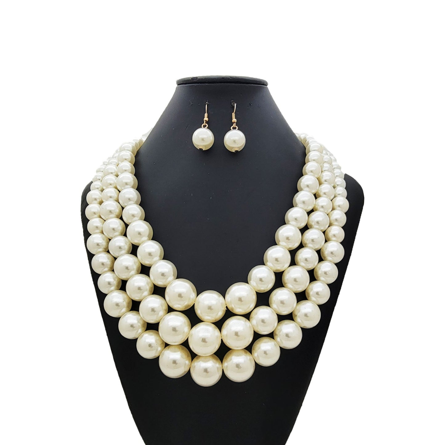 Cream Pearl necklace and earrings set on a black mannequin bust against a white background