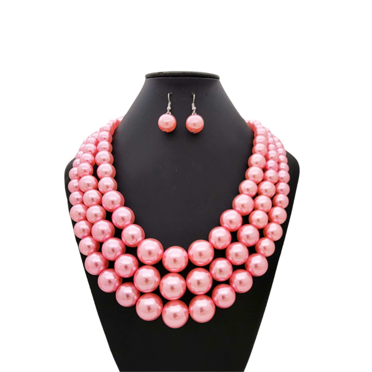 Pink pearl necklace and earrings set on a black mannequin bust against a white background