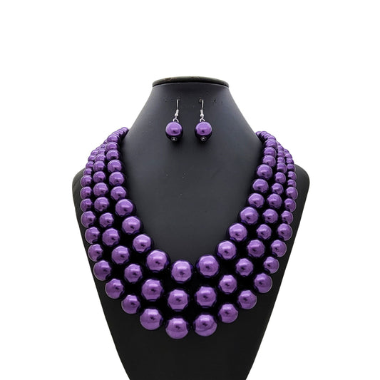 Purple beaded necklace and earrings on a black mannequin bust against a white background