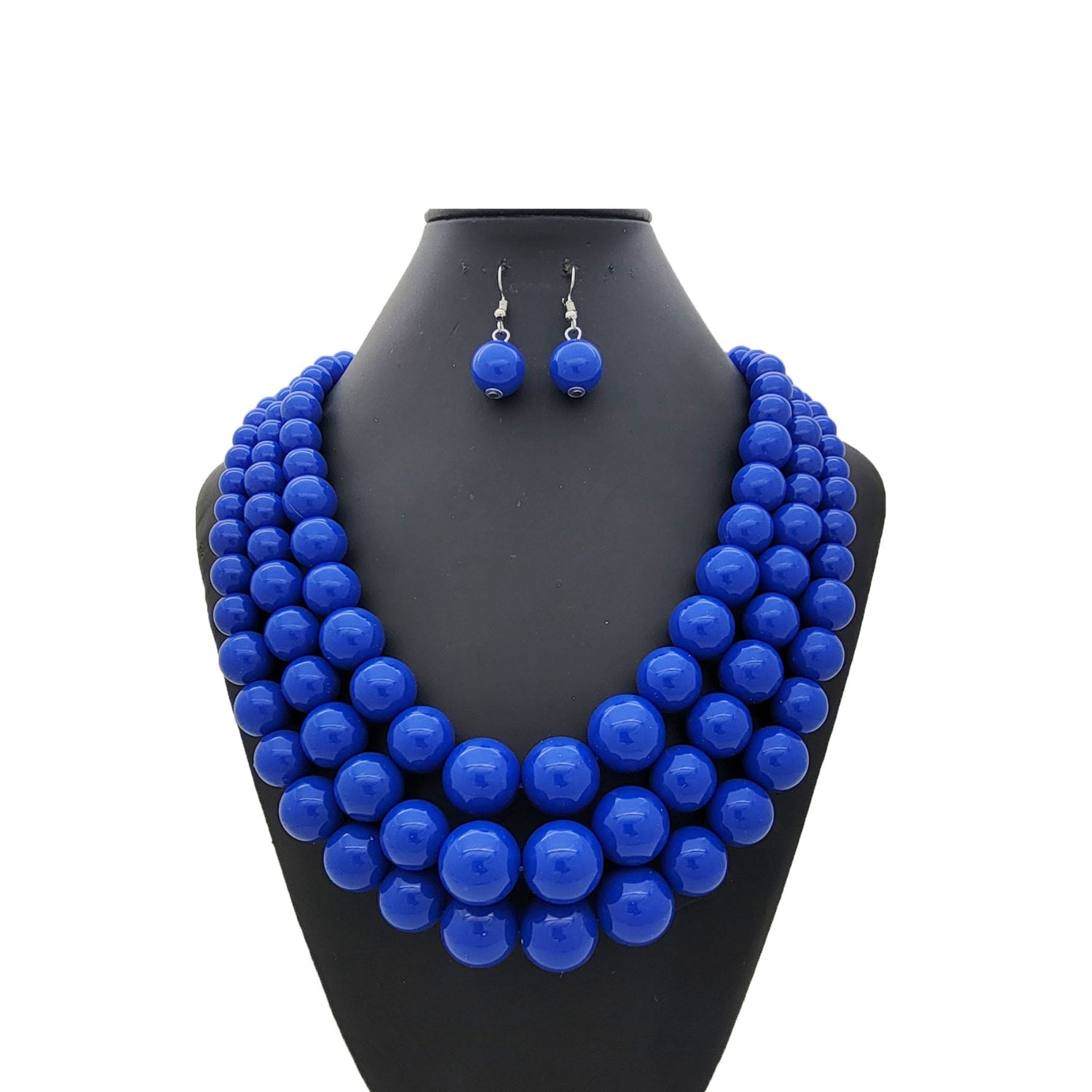 Blue beaded necklace and earrings on a black mannequin bust against a white background