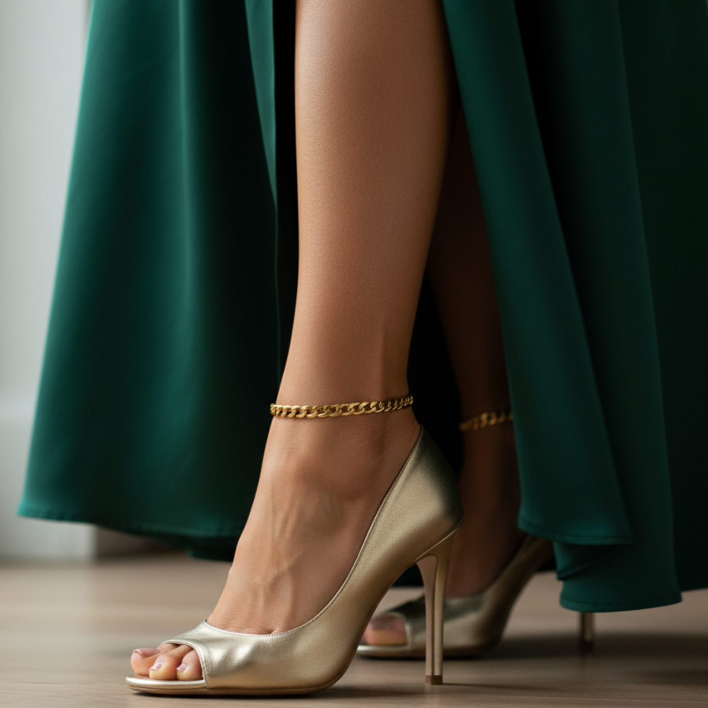 Gold high-heeled shoes worn with a green dress on a wooden floor.