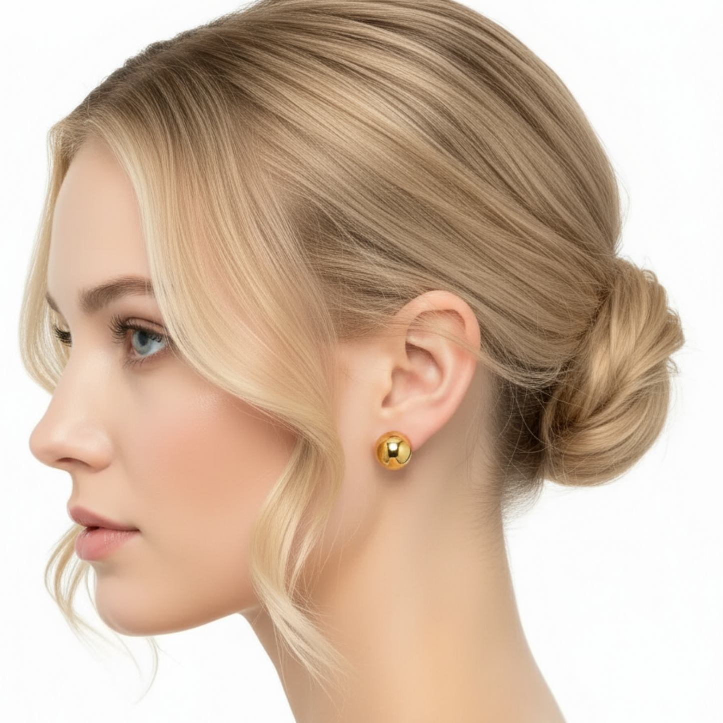 Woman wearing gold earrings with a white background