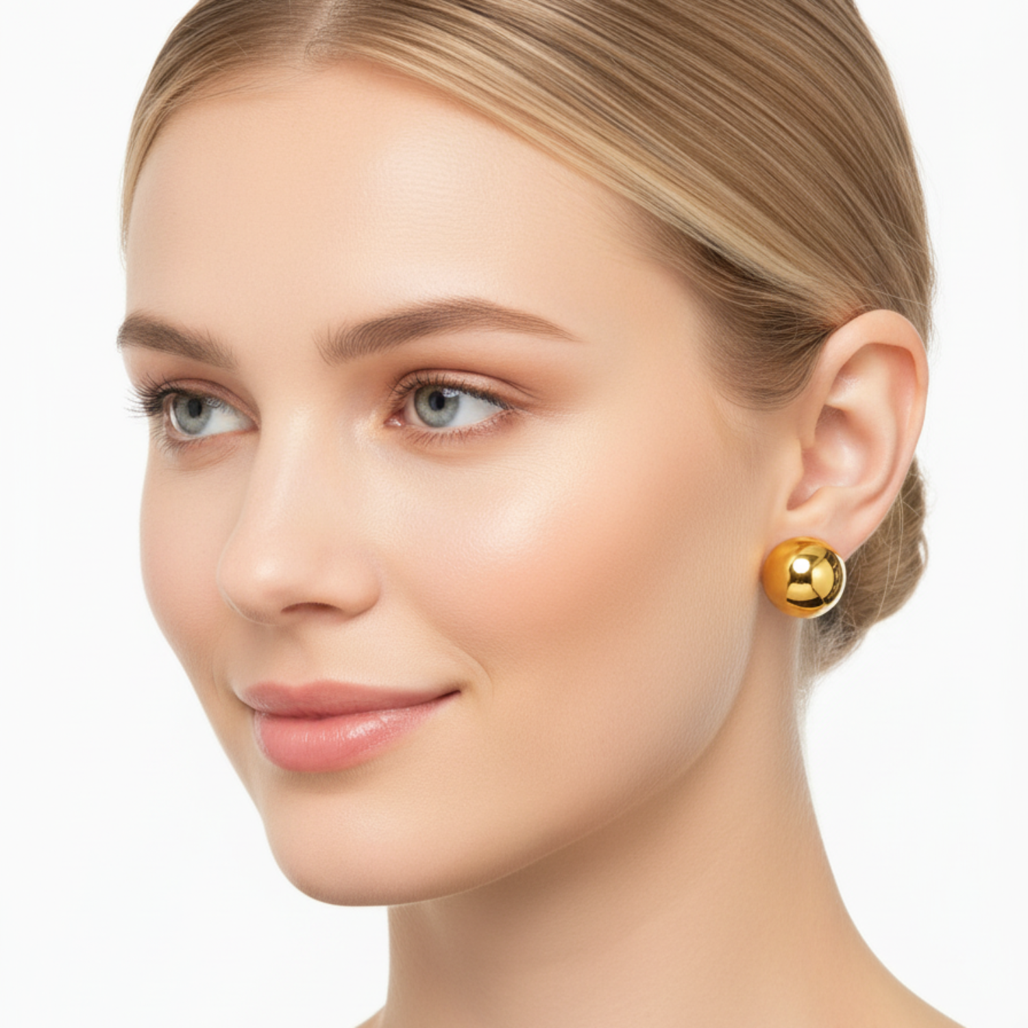 Woman wearing gold earrings on a white background