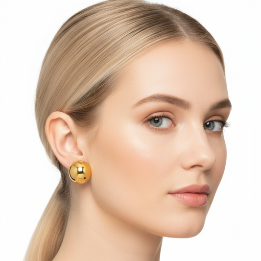 Woman wearing gold earrings on a white background
