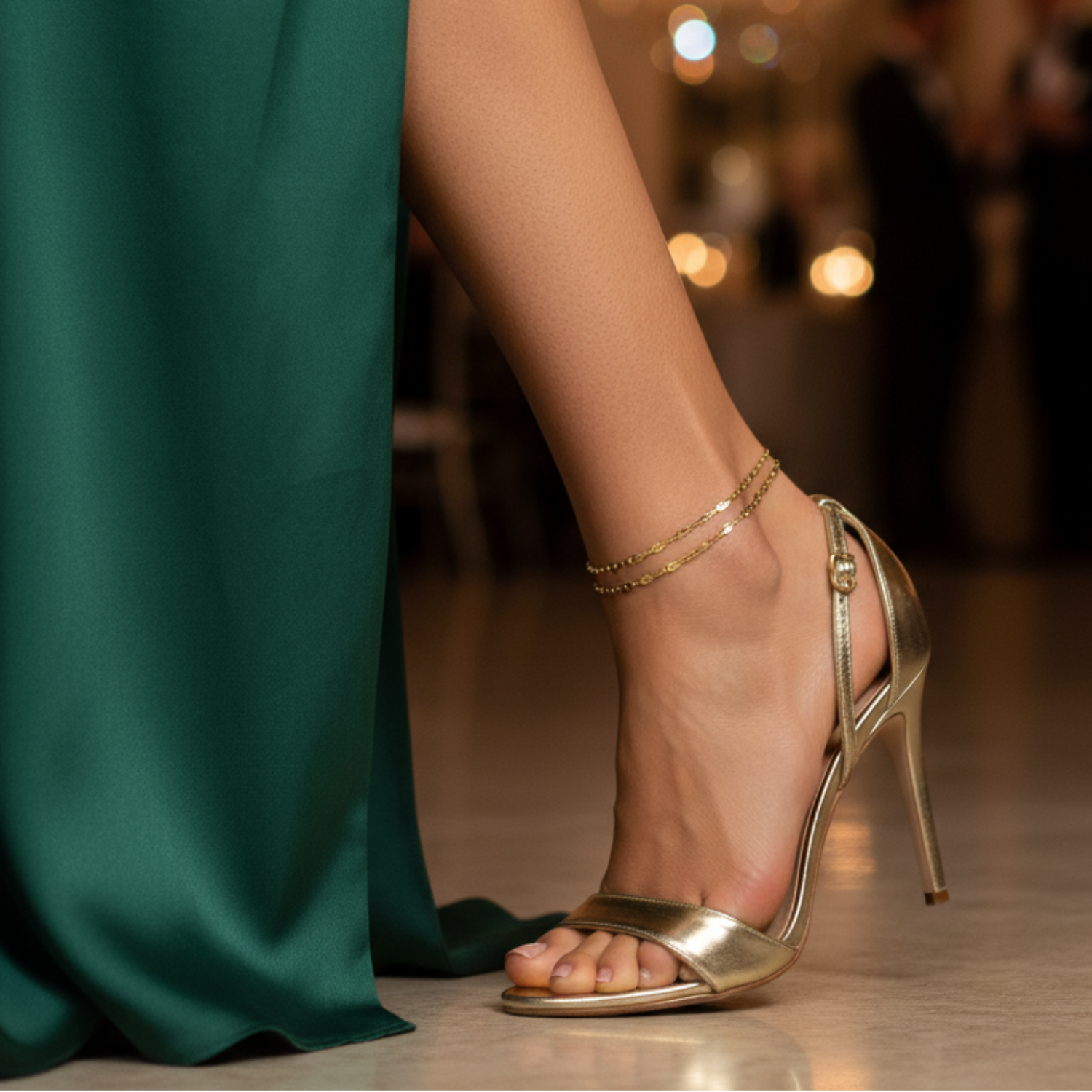 Gold Anklet on high-heeled shoe with a blurred formal event background