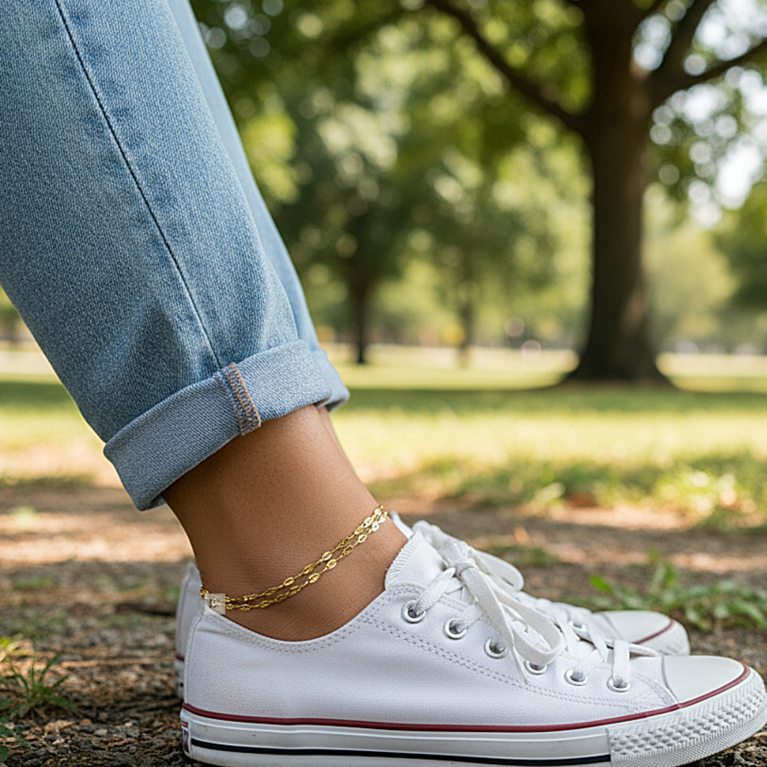 Wearing Double layer Anklet in white sneakers with red accents worn in a park setting