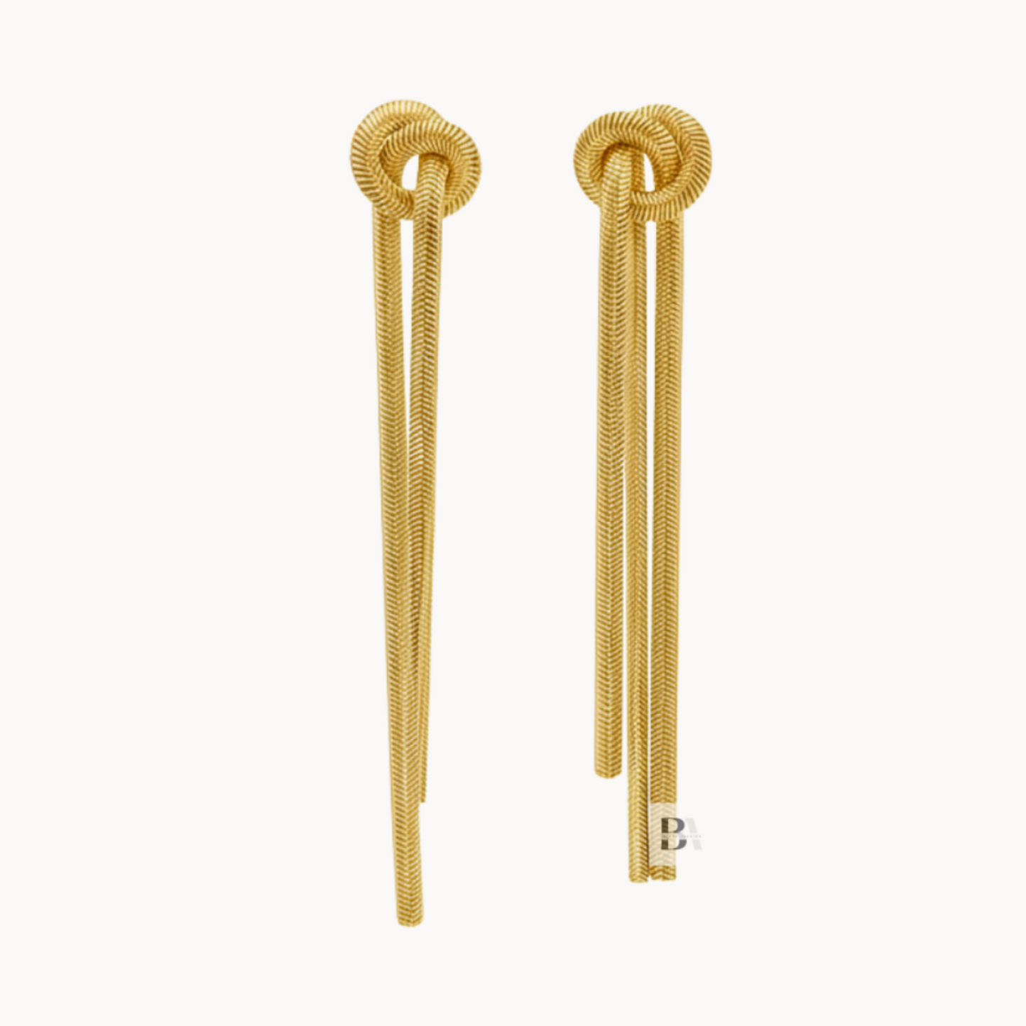Gold earrings with a knot design on a white background
