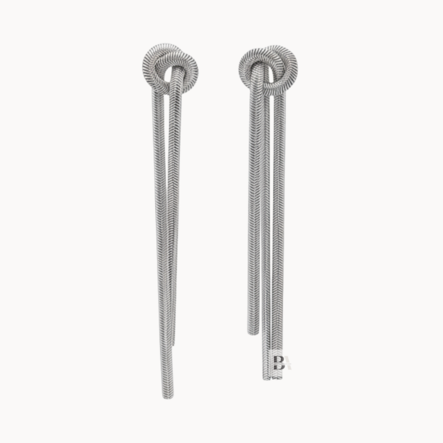 Pair of silver earrings on a white background