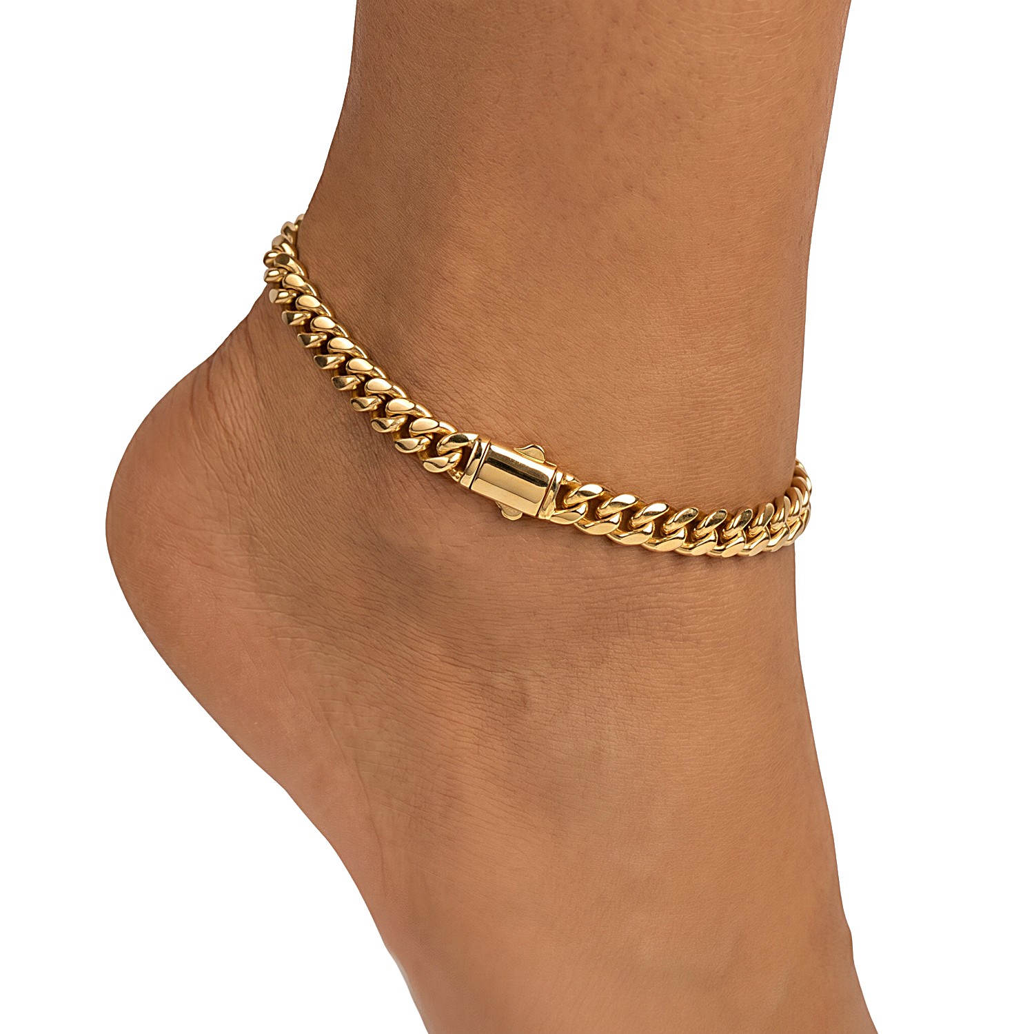A close-up of a gold-toned Cuban link chain anklet worn on a person's ankle, shown against a plain white background.