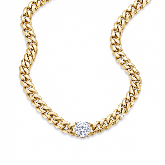 Gold chain necklace with a diamond on a white background