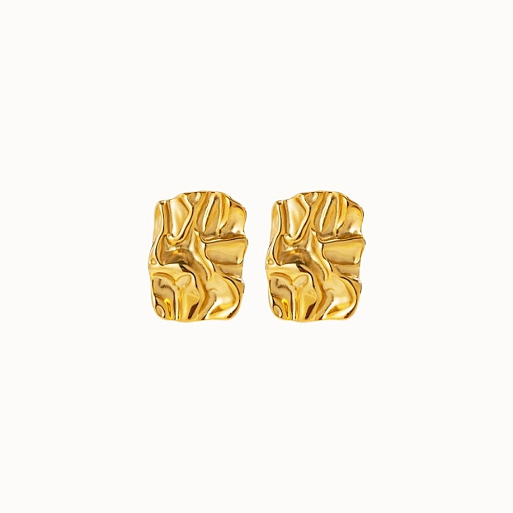 Pair of gold earrings on a white background