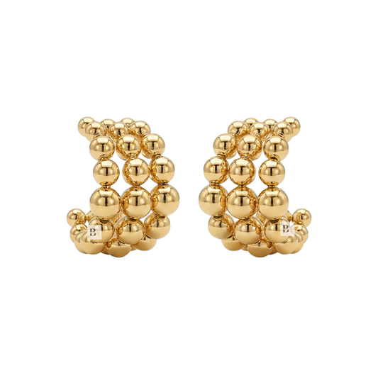 Pair of gold beaded earrings on a white background